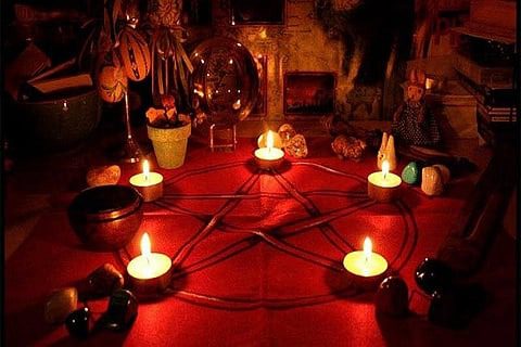 Candles arranged in a pentagram.